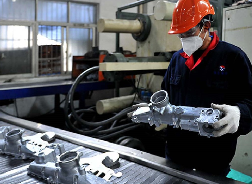Staff checking CNC precision machined parts quality